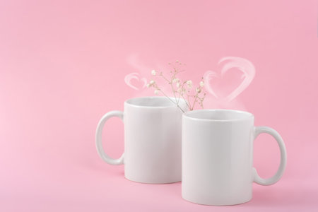 Mockup white coffe two cups or mug on a pink background with copy space. Blank template for your design, branding, business. real photo. Hot drink steam in the form of heartsの写真素材