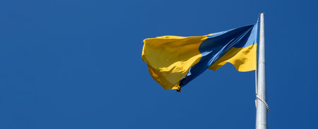 Flag of Ukraine flutters in blue sky. Large yellow blue Ukrainian national state flag. War Russia attacked Ukraineの写真素材
