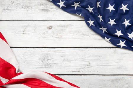 Flat lay USA flag on white wooden board, vintage background with copy space top view. Banner,...
