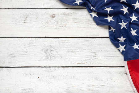 Flat lay USA flag on white wooden board, vintage background with copy space top view. Banner,...