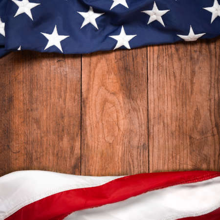 Flat lay USA flag on brown wooden board, vintage background with copy space top view. Banner,...