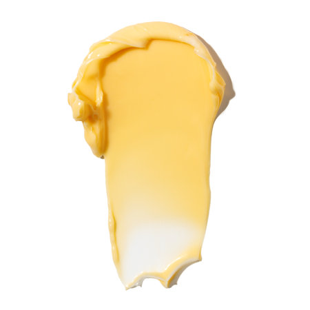 Swatch of yellow cream texture, cosmetics for face and body on a isolated white background. Drop smear. real photoの写真素材