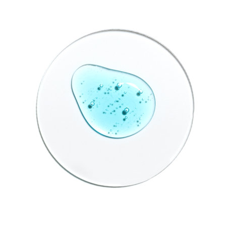 Texture swatch of blue hyaluronic acid serum gel on white isolated background, macro. Detergent, cosmetics, laboratory. A round drop in a petri dishの写真素材