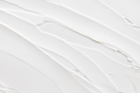 Swatch of white cream texture, cosmetics for face and body on a isolated light grey background. Smear.の写真素材