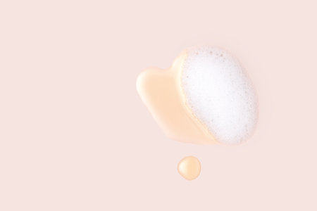 Face care washing cleansing with foam and hydrophilic oil, cosmetics on a beige background flat layの写真素材