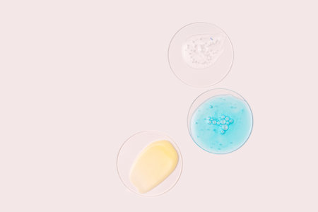 Stages of face care step by step. Face care washing cleansing with foam and hydrophilic oil, hyaluronic acid serum, retinol cream cosmetics on a beige background flat layの写真素材