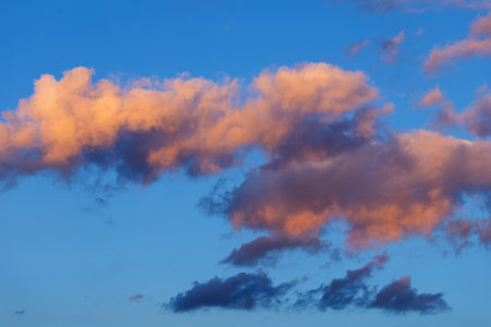 Pink orange clouds in the blue sky sunset