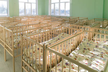 New baby beds in an empty preschool bedroom. new children's beds for toddlers, in kindergarten.の写真素材