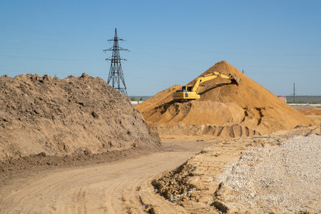 Crawler excavator, big yellow construction excavator at the construction site in a quarrying quarry....