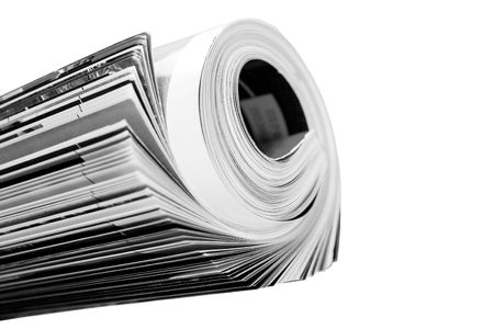 rolled up magazine over whiteの写真素材