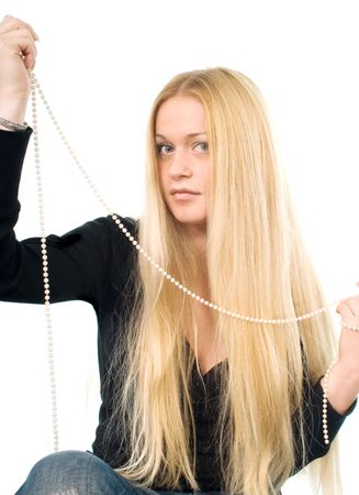 Portrait of the beautiful blond woman with a pearl necklace in her handsの写真素材