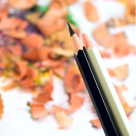 black and white pencils over sawdust backgroundの写真素材