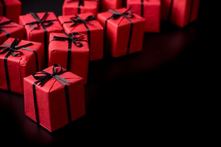 many red gift boxes on black backgroundの写真素材