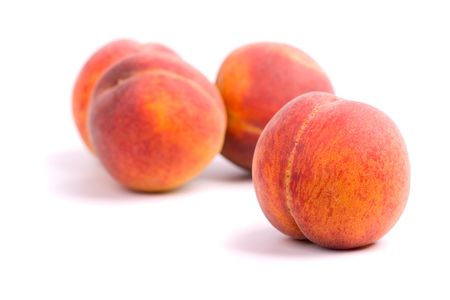 four peaches on white backgroundの写真素材