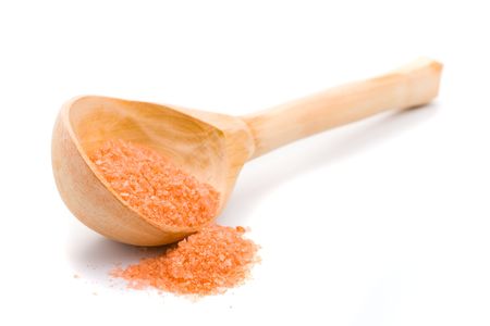 wooden spoon with sea salt isolated on white backgroundの写真素材