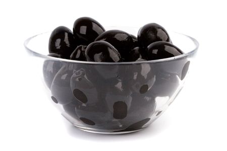bowl of black olives isolated on white backgroundの写真素材