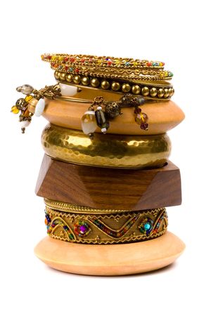 stack of metal and wooden bracelets isolated on white background