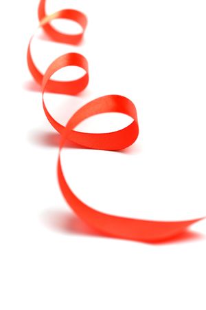 red satin ribbon closeup on white backgroundの写真素材