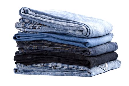 stack of blue jeans isolated on white backgroundの写真素材