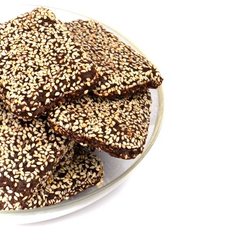 chocolate cookies with sesame seeds in a bowl closeupの写真素材