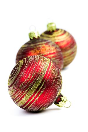 three red christmas balls isolated on white backgroundの写真素材