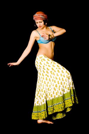 attractive woman dances east dance isolated on black backgroundの写真素材
