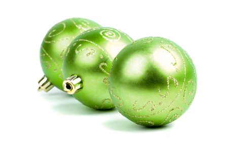 three green christmas balls isolated on white backgroundの写真素材