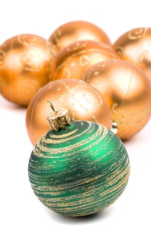 green and golden glass christmas balls closeup on white backgroundの写真素材