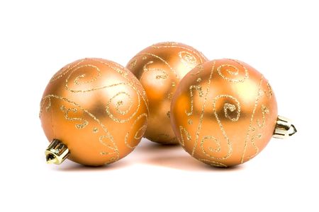 three golden glass christmas balls isolated on white backgroundの写真素材