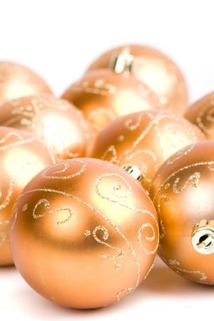 golden glass christmas balls closeup on white backgroundの写真素材