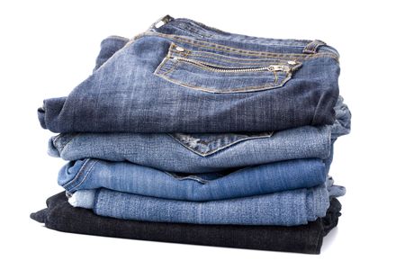 stack of blue jeans isolated on white backgroundの写真素材
