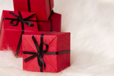 red gift boxes on white fur backgroundの写真素材