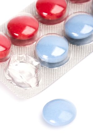 red and blue pills in plastic blister closeup