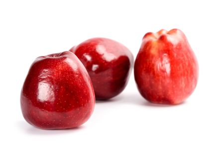 three red apples isolated on white backgroundの写真素材