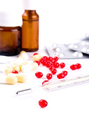 thermometer and different pills closeup on white backgroundの写真素材