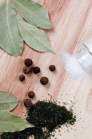spices: pepper, salt, bay leaves and herbs closeup on wooden background の写真素材