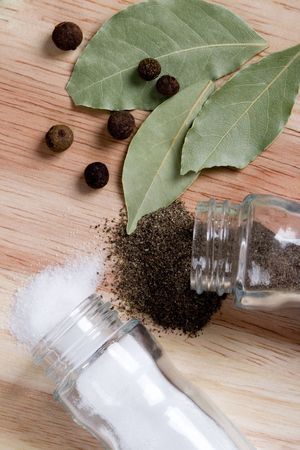 spices: pepper, salt and bay leaves closeup on wooden background の写真素材