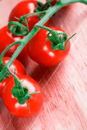tomatoes bunch closeup on wooden tableの写真素材