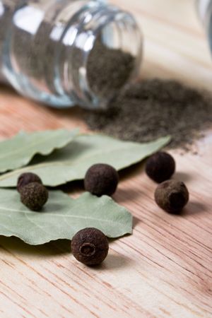 spices: pepper and bay leaves closeup on wooden background の写真素材
