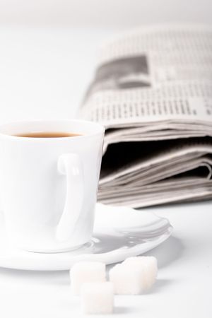 cup of coffee, sugar and stack of newspapers closeupの写真素材