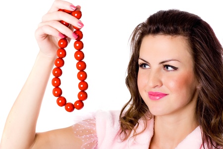 portrait of attractive brunet woman with red beads on white backgroundの写真素材