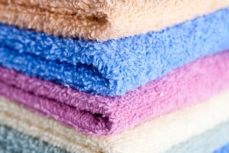 stacked colorful towels on a white background の写真素材