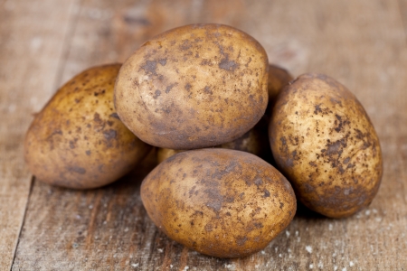 organic potatoes on a wooden backgroundの写真素材