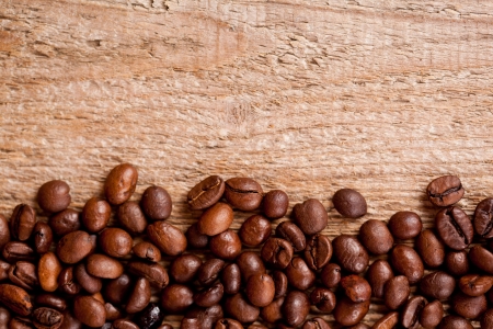 fresh coffee beans on rustic wooden board macro imageの写真素材
