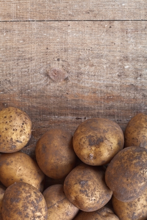 organic potatoes on a wooden backgroundの写真素材