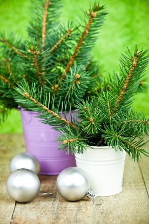 buckets with christmas fir tree and decorations on a wooden boardの写真素材
