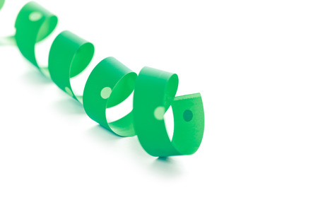 green ribbon serpentine isolated on white background の写真素材
