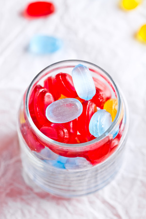 colorful candies in glass jarの写真素材