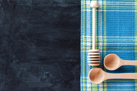 kitchen utensil and tablecloth over blackboard backgroundの写真素材