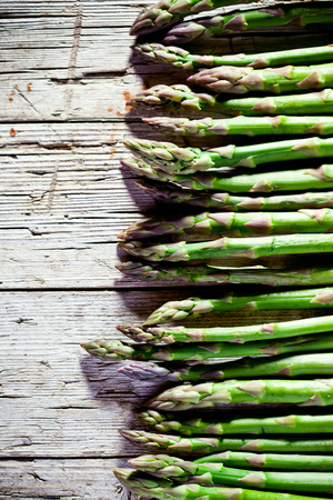 fresh asparagus on rustic wooden backgroundの写真素材